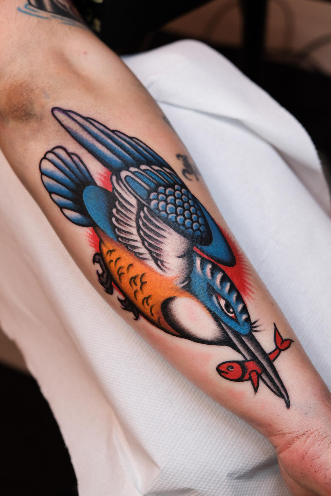 Kingfisher with goldfish color traditional tattoo made in Amsterdam.