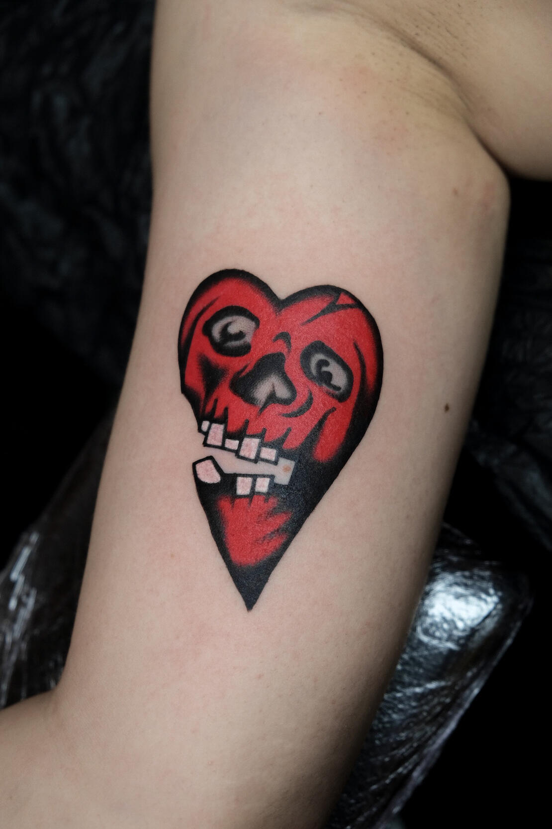 Broken heart/ skull, color traditional tattoo made in Amsterdam.