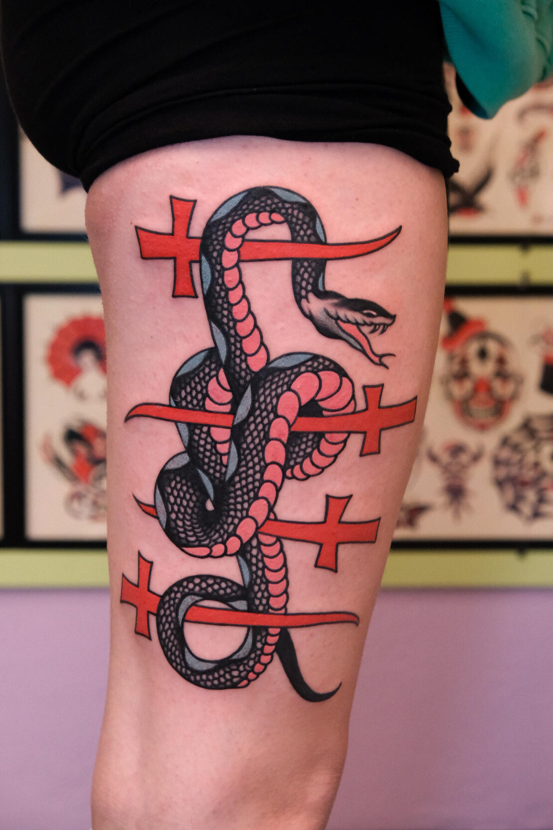 Pink snake with crossed swords, American traditional tattoo made in Italy.