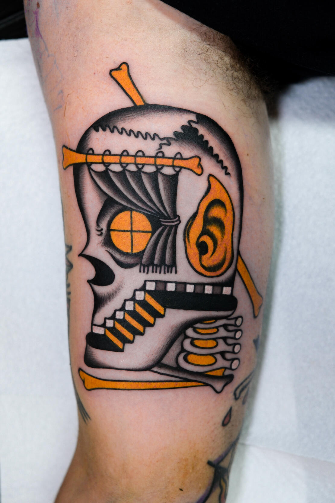 The house-skull with ear, color traditional tattoo made in Amsterdam.